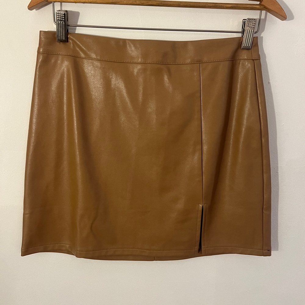 Faux leather light brown mini skirt with front side slit.  Size medium.